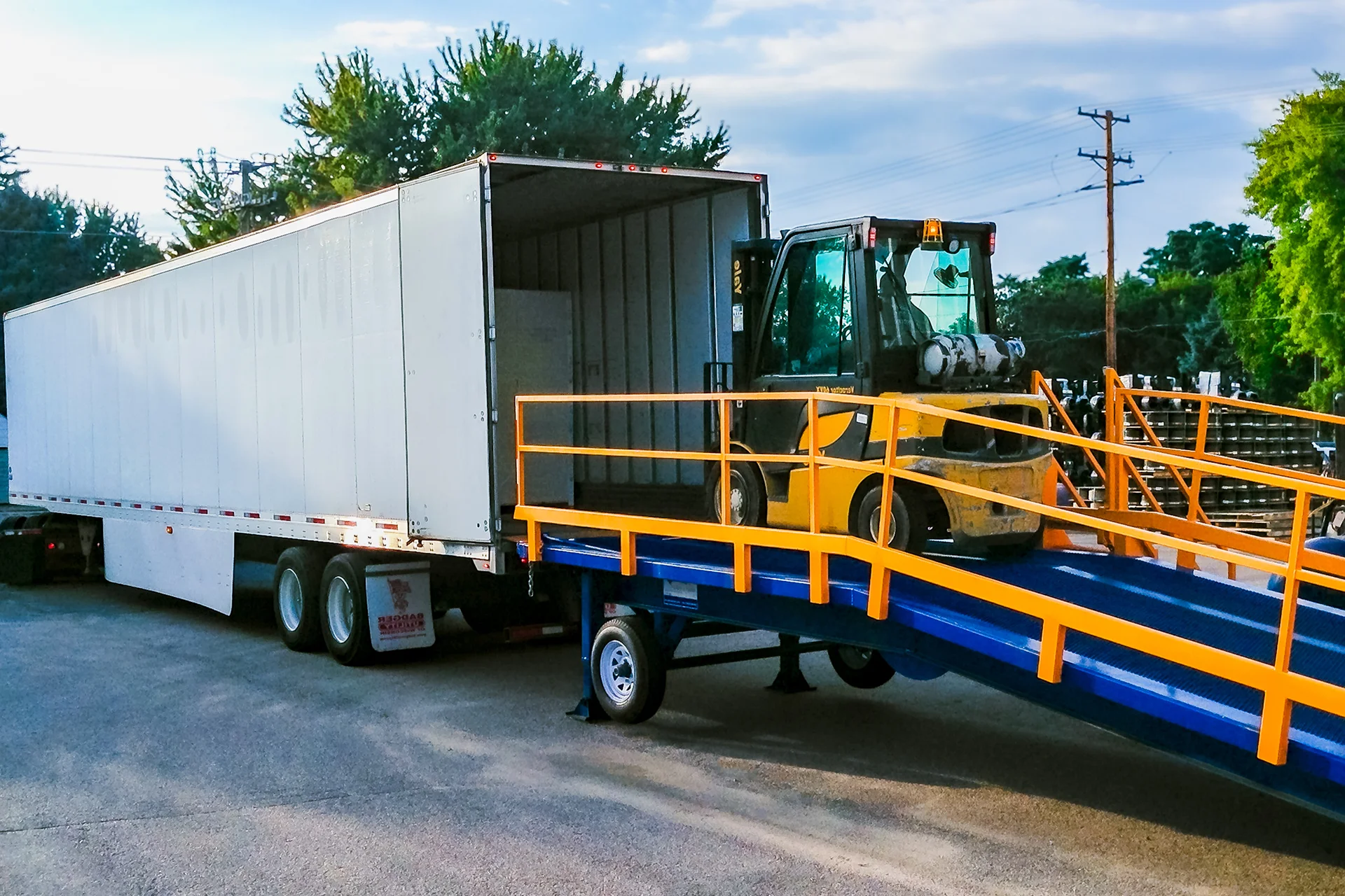 Adapt-A-Ramp with a forklift on it loading a trailer