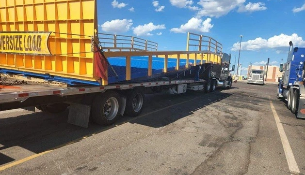 Adapt A ramp on the back of a flatbed trailer - ready for transport.